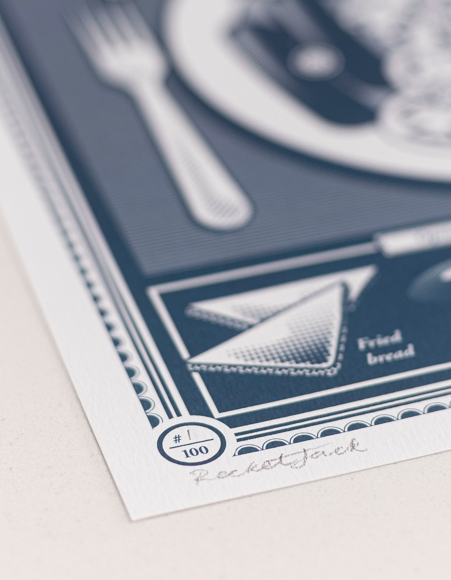 close up showing the paper stock limited edition Infographic art print depicting a diagram of the full english breakfast in monotone blue ink