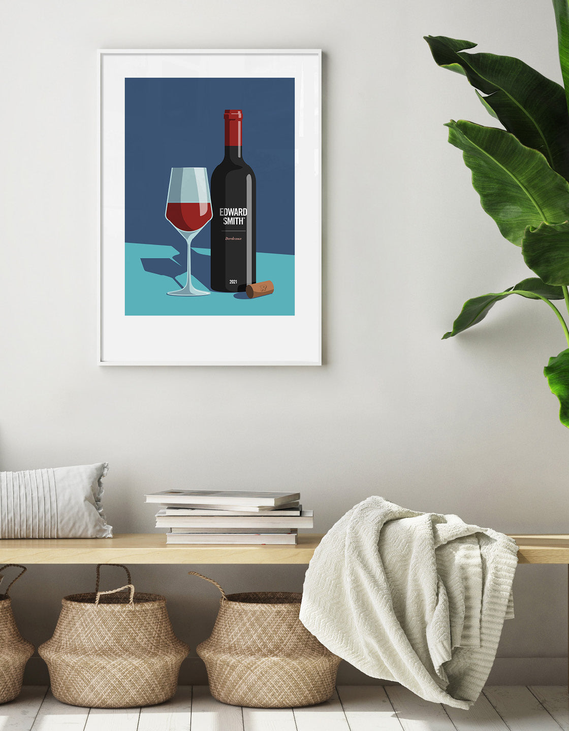 Minimal art print showing a wine glass half filled with red wine stood next to a bottle with white text. A cork lays on the side. Print has a dark blue background in the top two thirds and a turquoise background for the bottom third