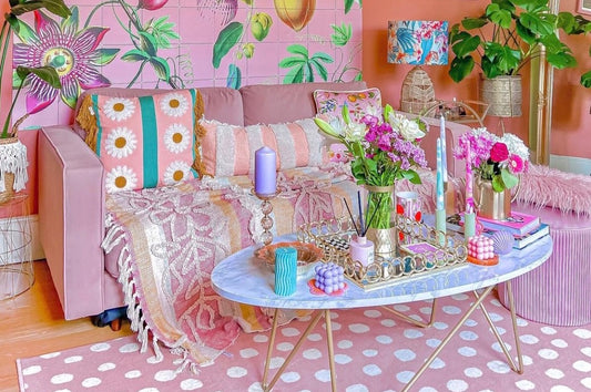 pink floral living room with pink velvet sofa and spotty rug