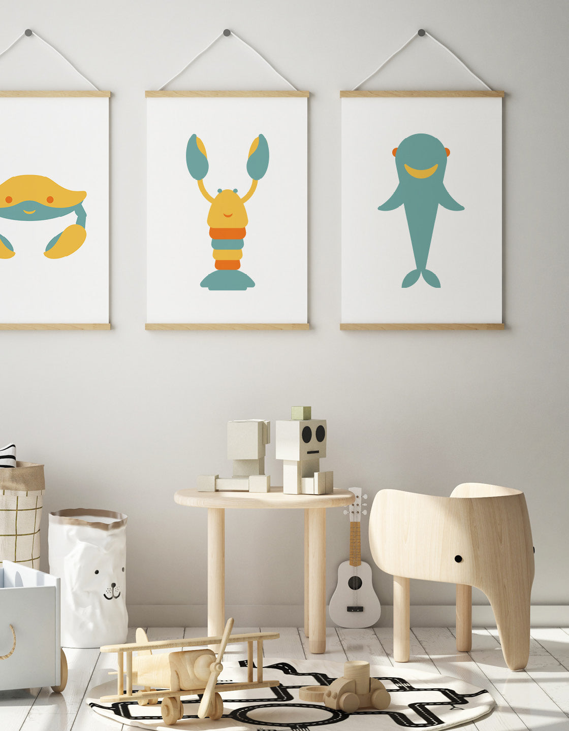 Kids playroom with desk, cute elephant chair and a trio of three art prints on the wall showing a crab, lobster and shark