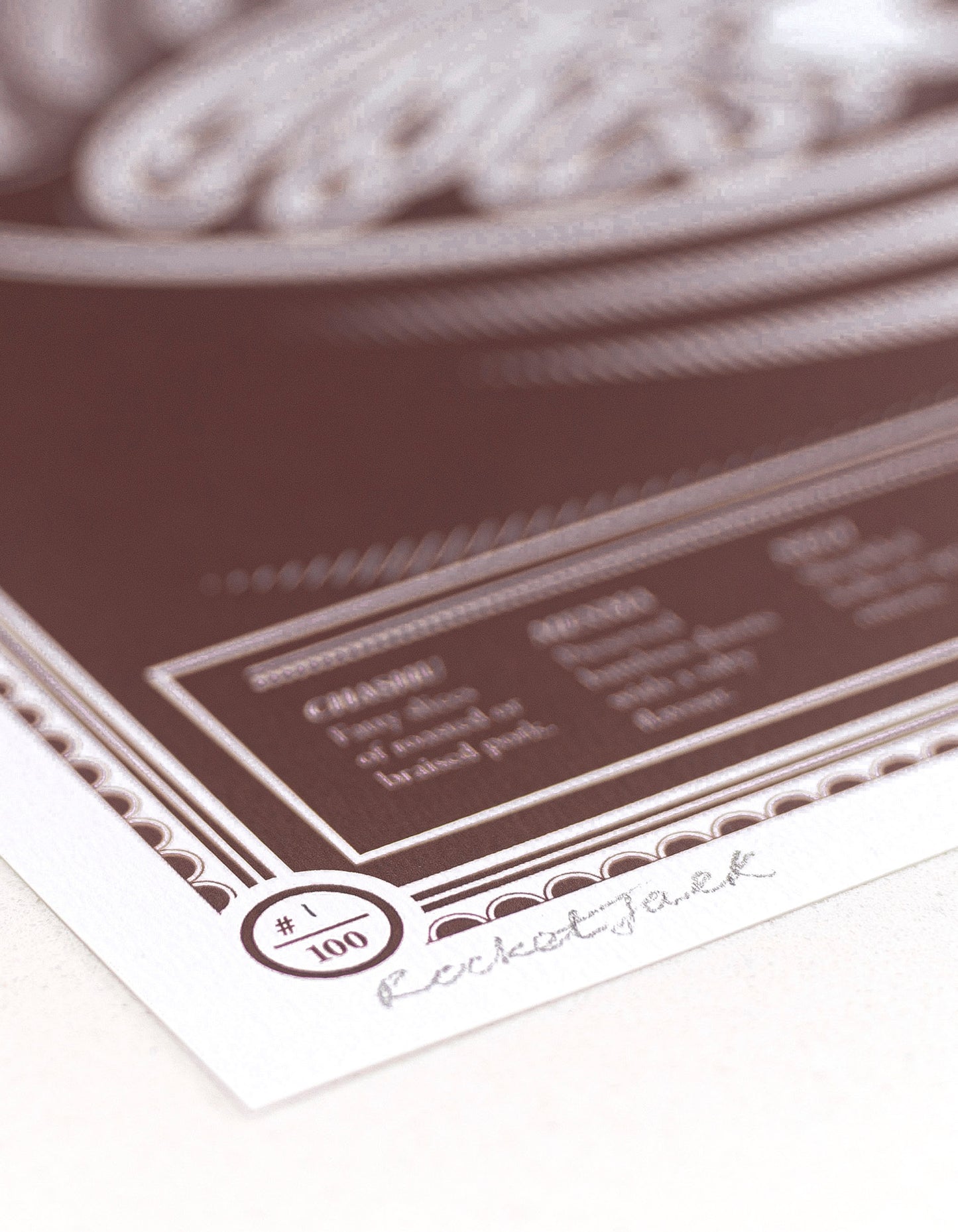 close up showing paper stock of limited edition Infographic art print depicting a diagram of the japanese ramen in monotone dark red ink