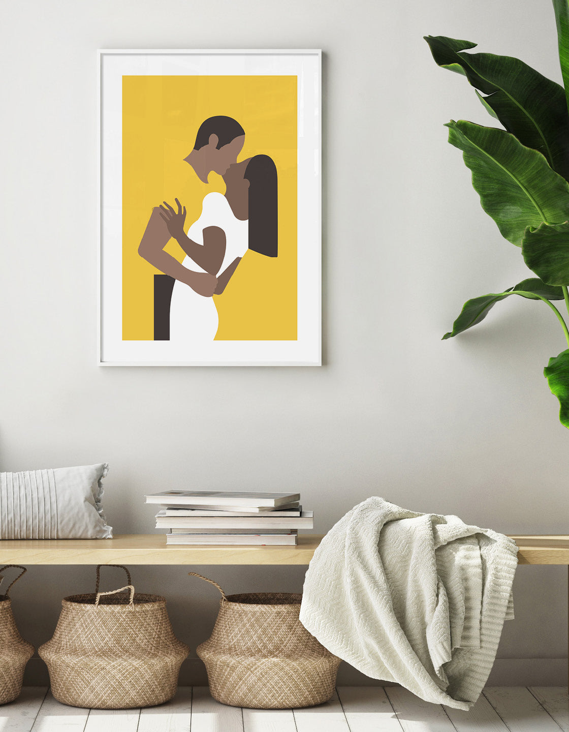 Yellow poster print depicts a couple in an embrace kissing. The woman is on the right wearing a white dress and the man's yellow t-shirt blends with the background