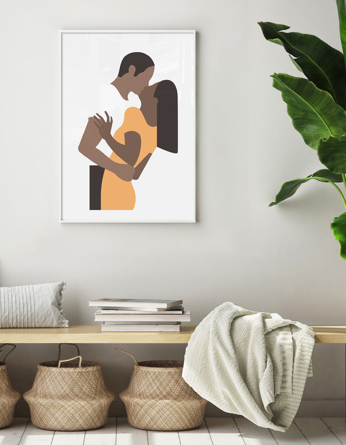 White poster print depicts a couple in an embrace kissing. The woman is on the right wearing a yellow dress and the man's white t-shirt blends with the background